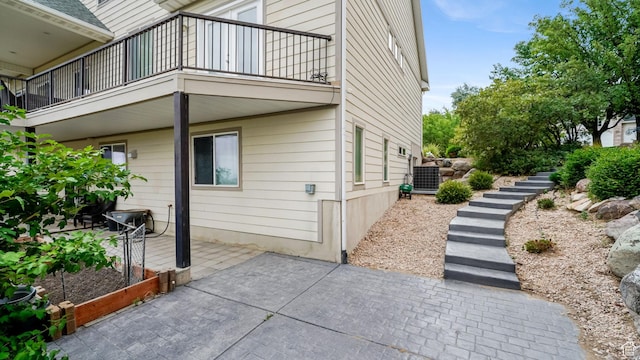 13994 S Stone Dr E, Draper, UT 84020 - view of property exterior featuring a balcony, a patio area, and stairway