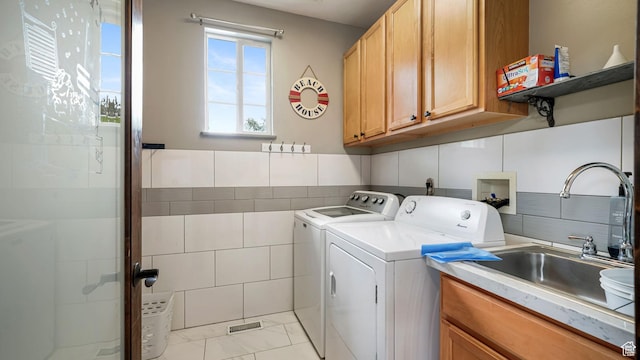 13994 S Stone Dr E, Draper, UT 84020 - washroom featuring cabinet space, separate washer and dryer, tile walls, and light marble finish floors