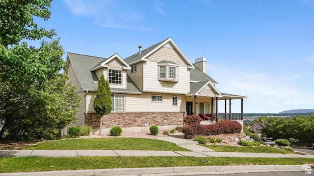13994 S Stone Dr E, Draper, UT 84020 - view of front of home with a porch, stone siding, a chimney, and roof with shingles