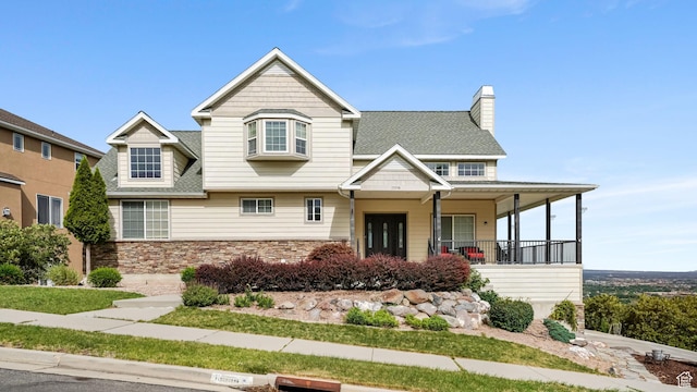 13994 S Stone Dr E, Draper, UT 84020 - view of front facade with stone siding, covered porch, and a chimney