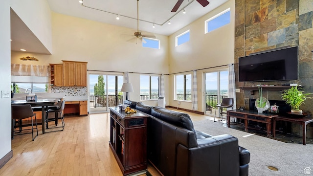 13994 S Stone Dr E, Draper, UT 84020 - living area featuring a ceiling fan, track lighting, light wood-style flooring, and a high ceiling