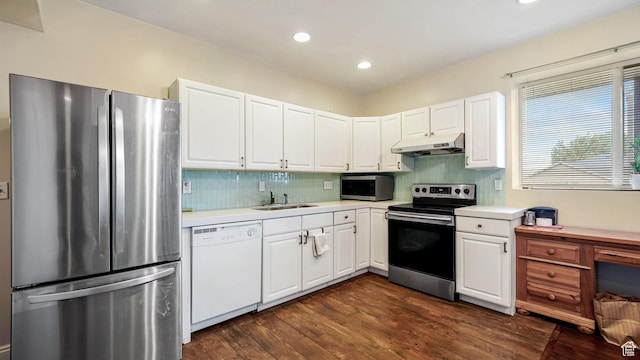 13994 S Stone Dr E, Draper, UT 84020 - kitchen featuring stainless steel appliances, under cabinet range hood, light countertops, dark wood-type flooring, and white cabinetry