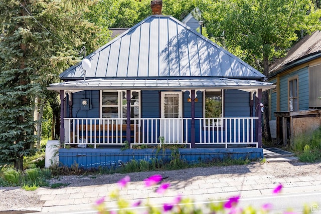 416 Marsac Ave, Park City, UT 84060 - view of front of house featuring covered porch, a chimney, a standing seam roof, and a metal roof