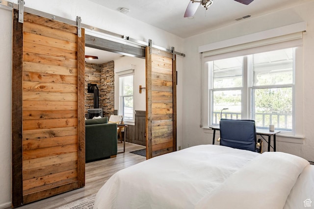 416 Marsac Ave, Park City, UT 84060 - bedroom with a barn door, light wood finished floors, and a ceiling fan