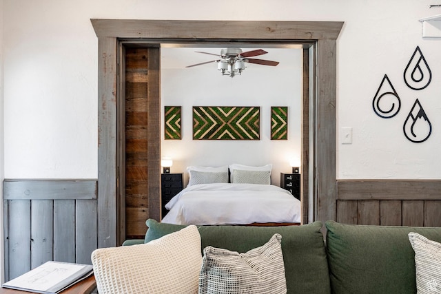 416 Marsac Ave, Park City, UT 84060 - bedroom featuring wainscoting, wooden walls, and ceiling fan