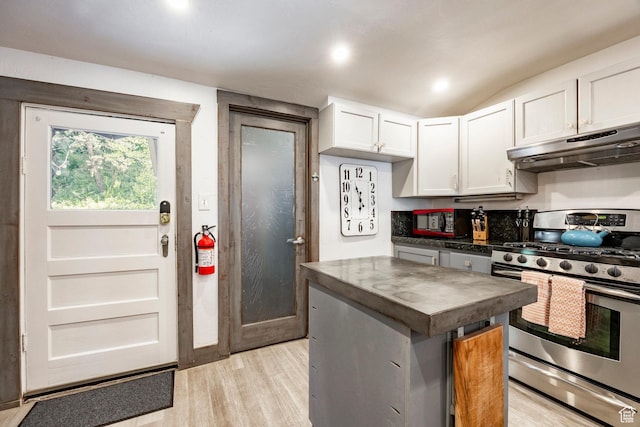 416 Marsac Ave, Park City, UT 84060 - kitchen featuring stainless steel range with gas cooktop, under cabinet range hood, light wood-style floors, white cabinets, and vaulted ceiling
