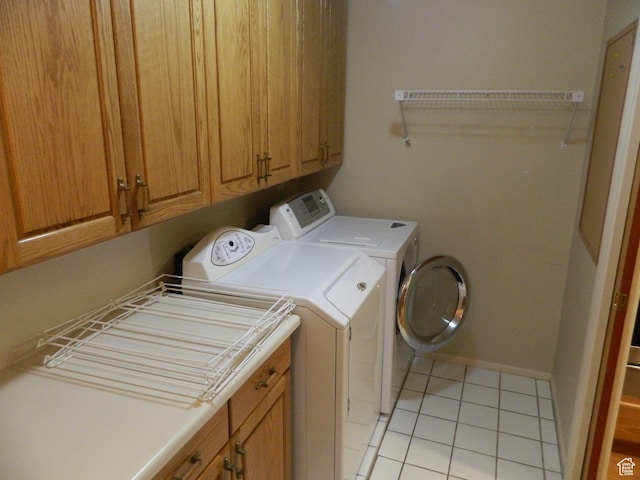 4222 S Edward Dr, Holladay, UT 84124 - laundry area with washing machine and clothes dryer, light tile patterned floors, and cabinet space
