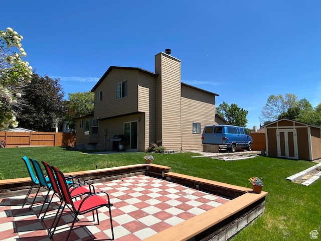 6690 S 3270 W, West Jordan, UT 84084 - rear view of property with a storage shed, a patio, and a chimney