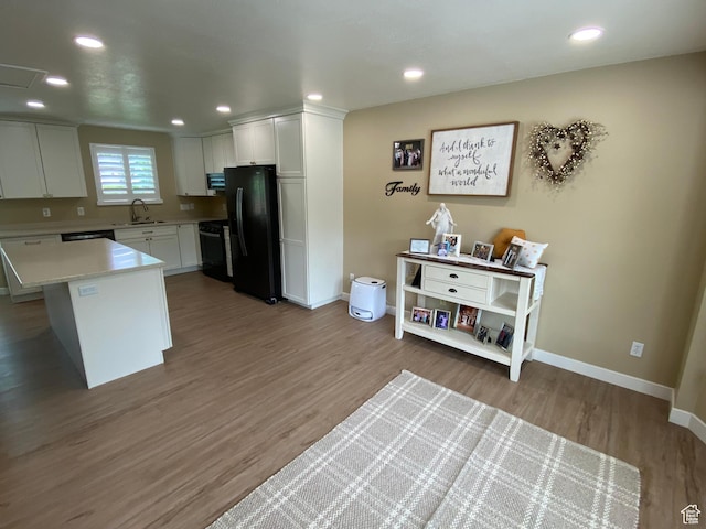 6690 S 3270 W, West Jordan, UT 84084 - kitchen featuring freestanding refrigerator, light wood-type flooring, white cabinets, light countertops, and stove