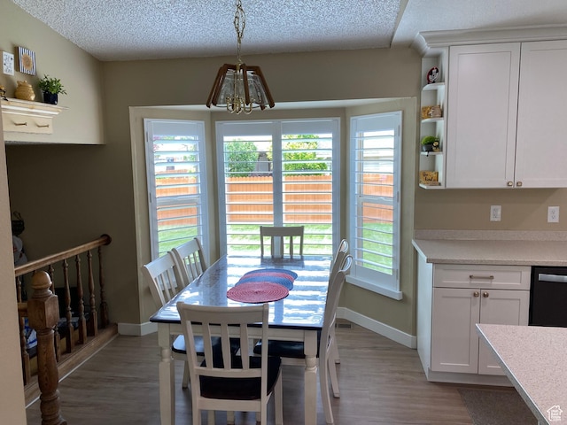 6690 S 3270 W, West Jordan, UT 84084 - dining area with a chandelier, light wood finished floors, healthy amount of natural light, and a textured ceiling