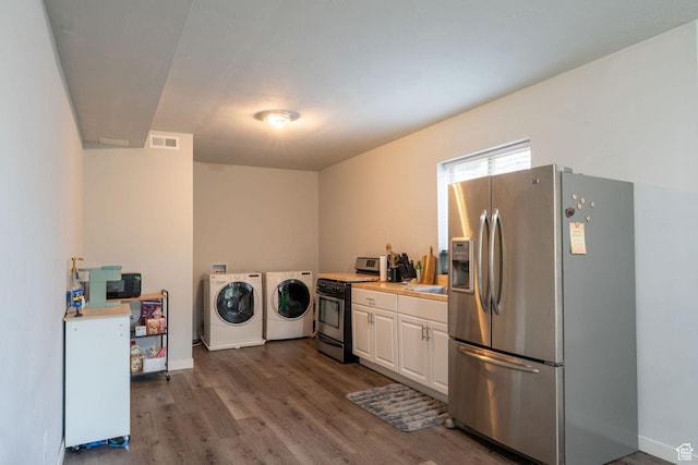 1959 W Golden Pond Way S, Orem, UT 84059 - laundry area featuring washing machine and clothes dryer and wood finished floors