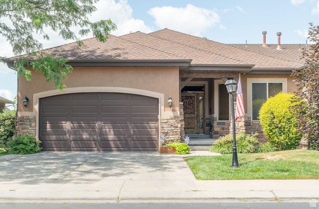 1959 W Golden Pond Way S, Orem, UT 84059 - view of front of home featuring stone siding, a garage, stucco siding, and driveway