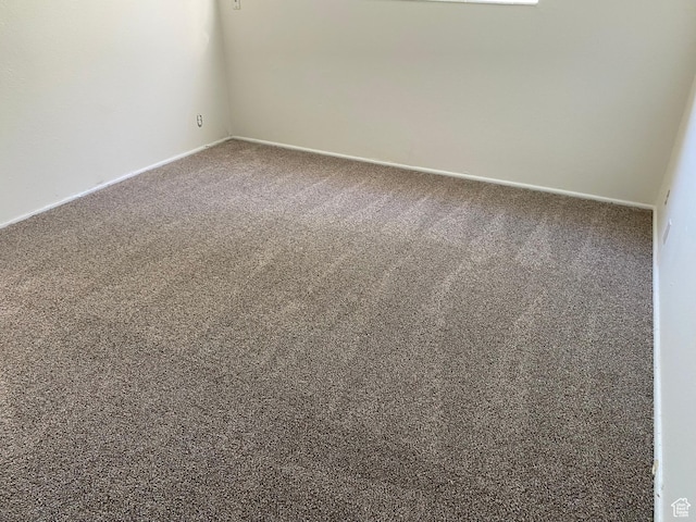 768 N Redwood Rd W Unit 01, Salt Lake City, UT 84116 - carpeted empty room with baseboards
