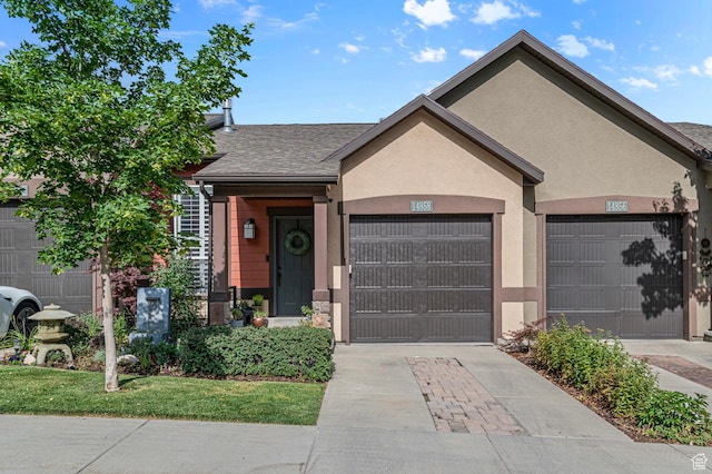 14858 S Ox Cart Ln, Draper, UT 84020 - view of front of property featuring concrete driveway, an attached garage, a shingled roof, and stucco siding