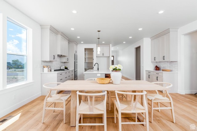 2960 N 1080 W, Lehi, UT 84043 - kitchen with decorative backsplash, light wood finished floors, light countertops, healthy amount of natural light, and recessed lighting