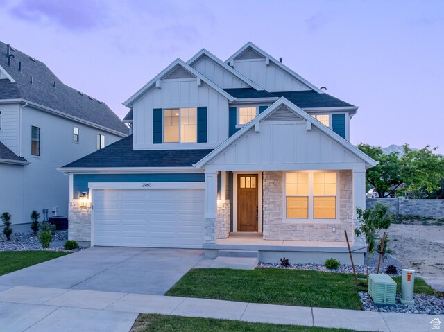 2960 N 1080 W, Lehi, UT 84043 - view of front of property with board and batten siding, covered porch, stone siding, concrete driveway, and a garage