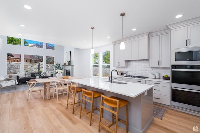 2960 N 1080 W, Lehi, UT 84043 - kitchen featuring stainless steel double oven, light countertops, backsplash, light wood finished floors, and gas stovetop