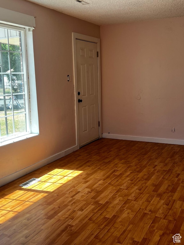 1145 S Navajo St, Salt Lake City, UT 84104 - empty room featuring wood finished floors and a textured ceiling
