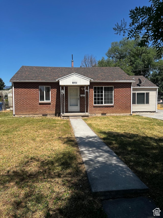 1145 S Navajo St, Salt Lake City, UT 84104 - view of front of home with brick siding, a front yard, and a shingled roof