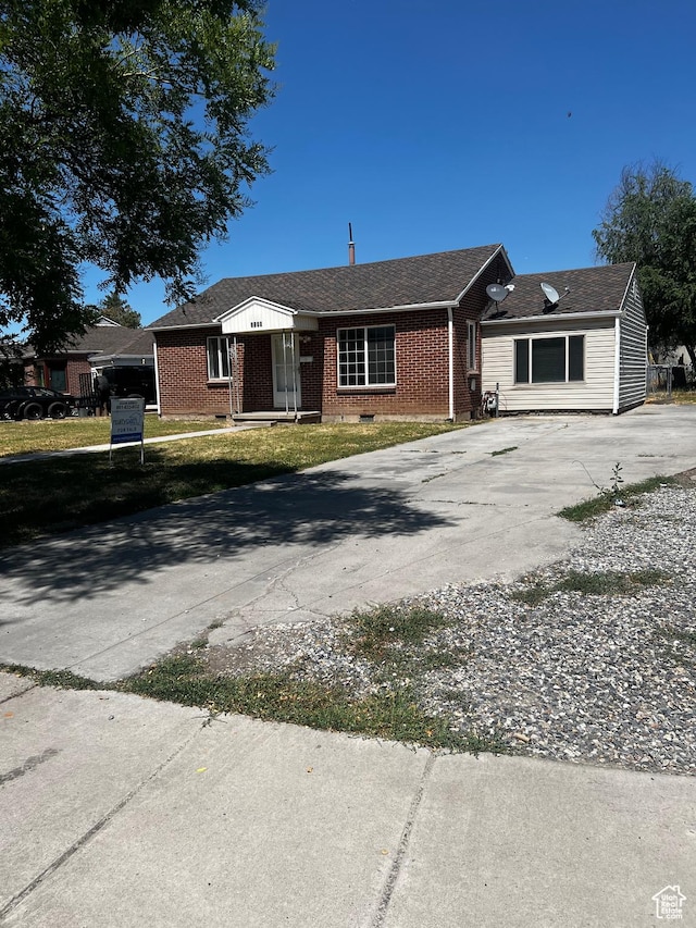 1145 S Navajo St, Salt Lake City, UT 84104 - view of front of property with concrete driveway and brick siding
