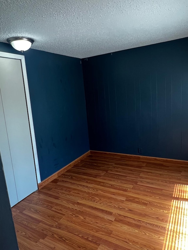 1145 S Navajo St, Salt Lake City, UT 84104 - empty room with wood finished floors and a textured ceiling
