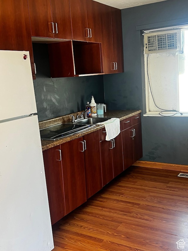 1145 S Navajo St, Salt Lake City, UT 84104 - kitchen with freestanding refrigerator, wood finished floors, and an AC wall unit