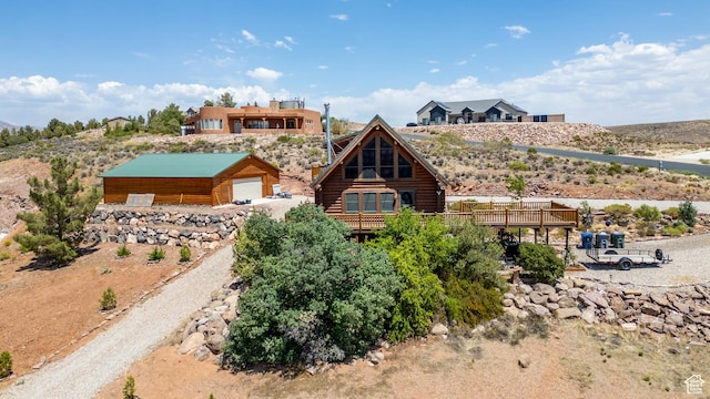 214 W Shinarump Cir, Leeds, UT 84746 - view of front of house featuring log siding, a detached garage, and an outbuilding