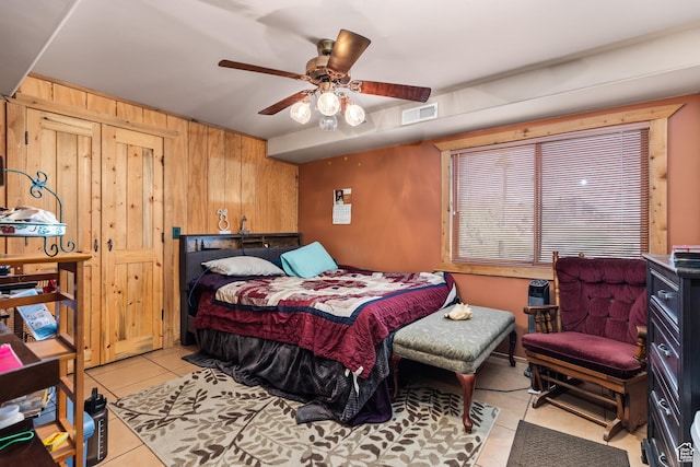 214 W Shinarump Cir, Leeds, UT 84746 - bedroom with light tile patterned flooring, wooden walls, and a ceiling fan