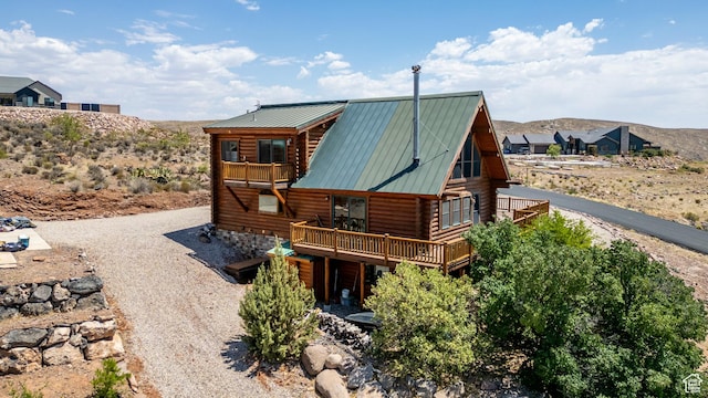 214 W Shinarump Cir, Leeds, UT 84746 - rear view of house featuring log exterior, a balcony, a metal roof, and a deck
