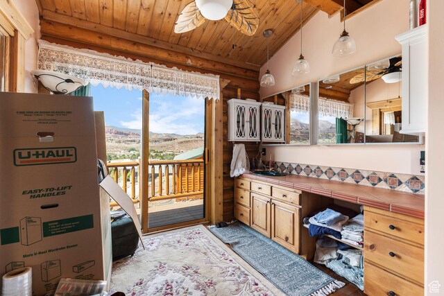 214 W Shinarump Cir, Leeds, UT 84746 - bathroom featuring log walls, ceiling fan, a wood ceiling with exposed beams, a mountain view, and wood finished floors