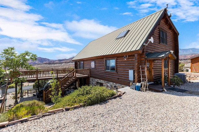 214 W Shinarump Cir, Leeds, UT 84746 - view of property exterior with a standing seam roof, a metal roof, log siding, and stairs