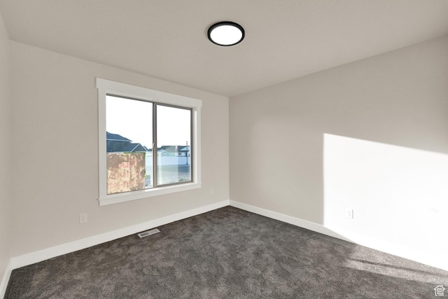 1182 N Berra Blvd, Tooele, UT 84074 - empty room with dark colored carpet and baseboards