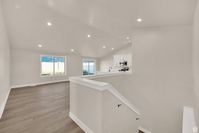 1182 N Berra Blvd, Tooele, UT 84074 - corridor with recessed lighting, light wood-style floors, and vaulted ceiling