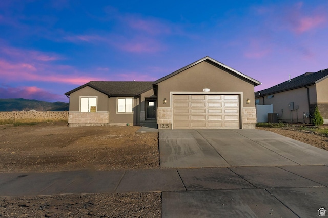 1182 N Berra Blvd, Tooele, UT 84074 - ranch-style home with stucco siding, an attached garage, driveway, and stone siding