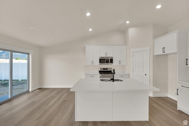 1182 N Berra Blvd, Tooele, UT 84074 - kitchen with stainless steel appliances, light wood finished floors, a center island with sink, light countertops, and recessed lighting