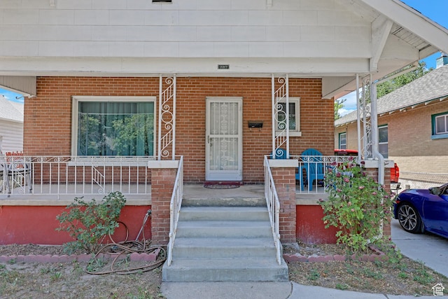 2217 Monroe Blvd, Ogden, UT 84401 - property entrance featuring a porch and brick siding