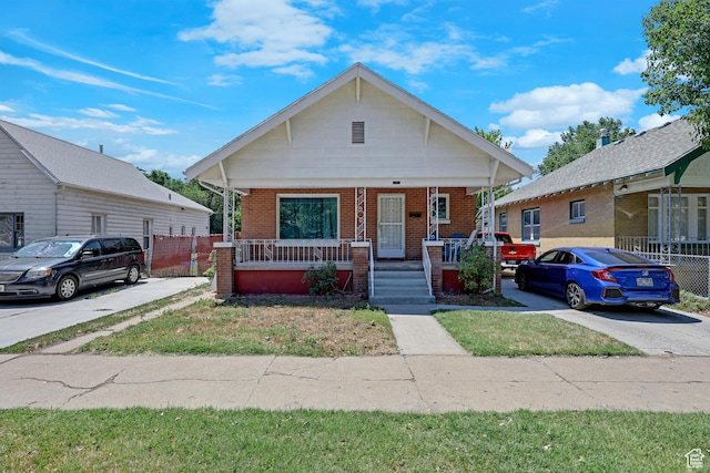 2217 Monroe Blvd, Ogden, UT 84401 - bungalow-style home featuring a porch and brick siding