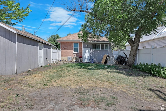 2217 Monroe Blvd, Ogden, UT 84401 - rear view of property with a fenced backyard, brick siding, and an outbuilding