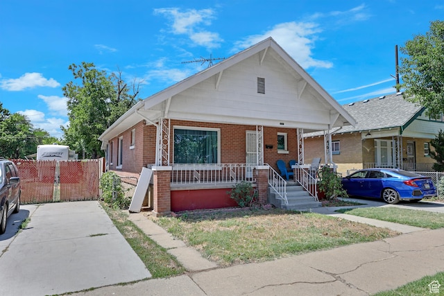 2217 Monroe Blvd, Ogden, UT 84401 - bungalow-style house featuring a porch and brick siding