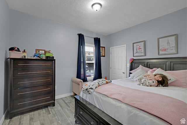 2217 Monroe Blvd, Ogden, UT 84401 - bedroom with light wood-style flooring and a textured ceiling