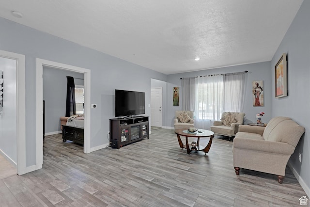 2217 Monroe Blvd, Ogden, UT 84401 - living room with healthy amount of natural light, light wood finished floors, and a textured ceiling