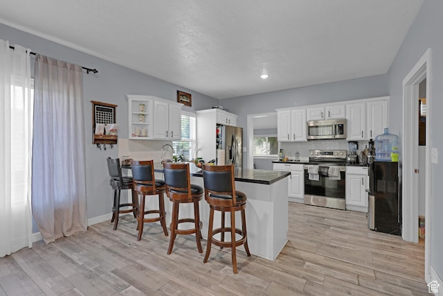 2217 Monroe Blvd, Ogden, UT 84401 - kitchen with stainless steel appliances, a peninsula, and white cabinetry