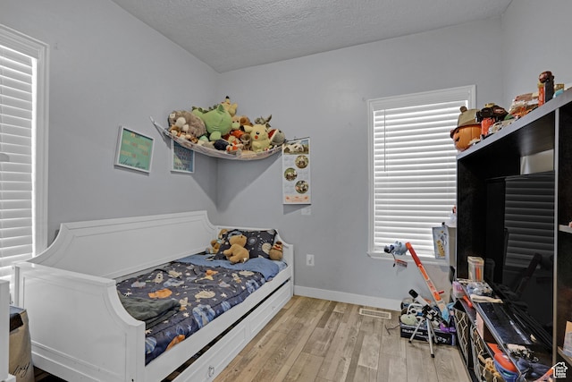2217 Monroe Blvd, Ogden, UT 84401 - bedroom featuring light wood-style floors and a textured ceiling
