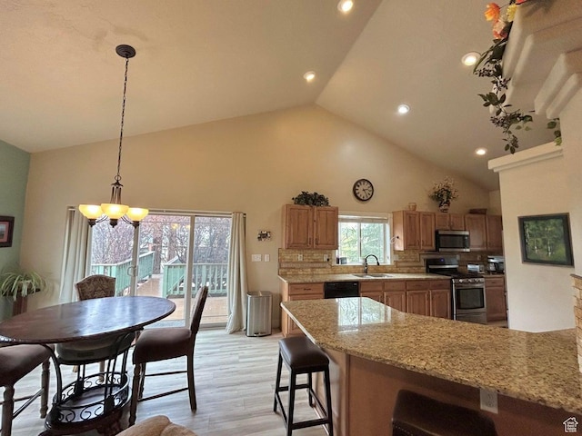 4140 W 975 S, Cedar City, UT 84720 - kitchen with appliances with stainless steel finishes, decorative backsplash, high vaulted ceiling, a chandelier, and light wood-type flooring