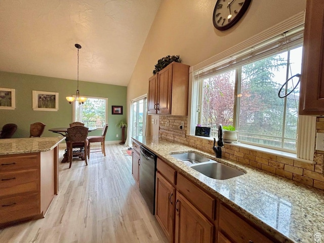 4140 W 975 S, Cedar City, UT 84720 - kitchen featuring dishwashing machine, brown cabinetry, backsplash, light wood-type flooring, and vaulted ceiling