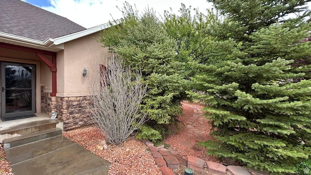 4140 W 975 S, Cedar City, UT 84720 - doorway to property featuring stucco siding, stone siding, and roof with shingles