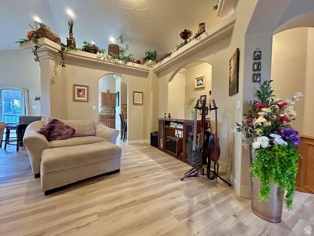 4140 W 975 S, Cedar City, UT 84720 - living area featuring arched walkways, light wood-style flooring, and a towering ceiling