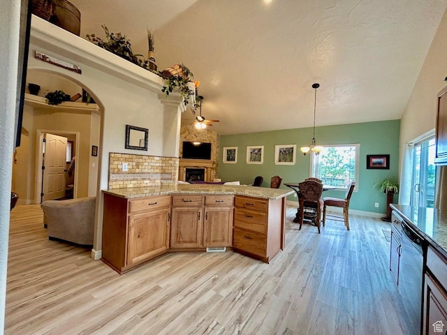 4140 W 975 S, Cedar City, UT 84720 - kitchen featuring stainless steel dishwasher, a large fireplace, light wood-style floors, open floor plan, and a peninsula