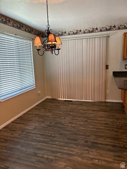 1579 W 2050 N, Clinton, UT 84015 - unfurnished dining area with a chandelier and dark wood finished floors