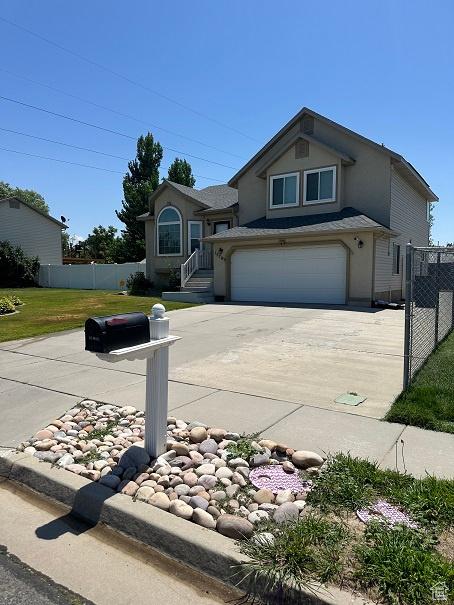 1579 W 2050 N, Clinton, UT 84015 - view of front of home featuring concrete driveway, stucco siding, and an attached garage